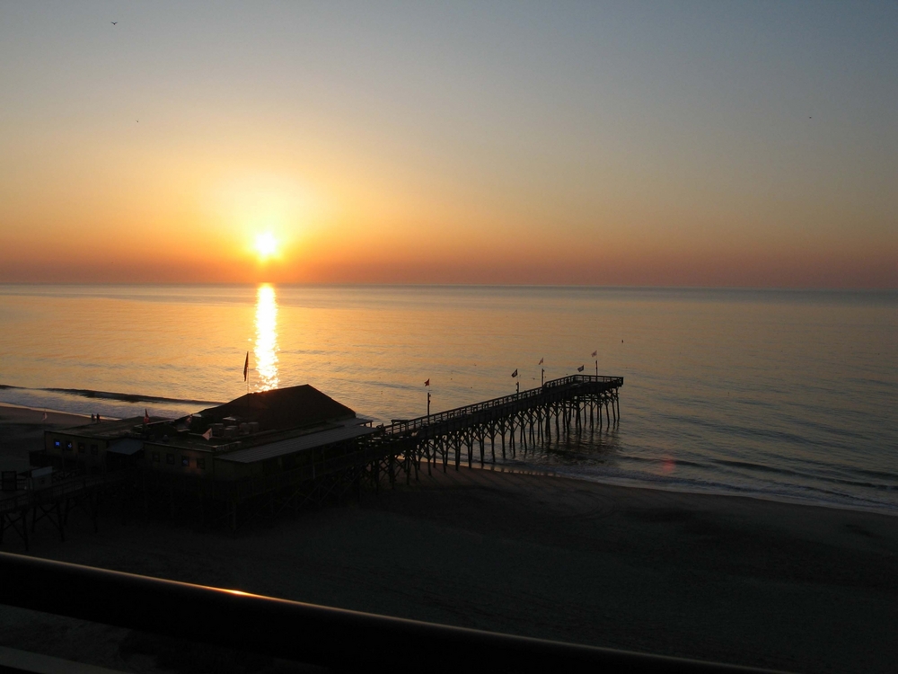 Holiday Pavilion Oceanfront Resort Vacation Rental Condo view of the sunrise over Pier 14