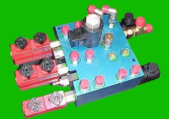 Hydraulic manifold saved both space and cost on an aircraft cargo loader.