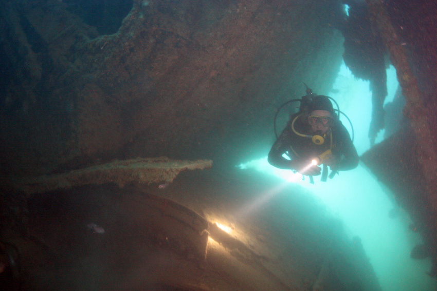 Diver swimming past boilers