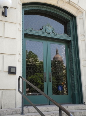 Door to the Texas Secretary of State's Office with Reflection of Capitol
